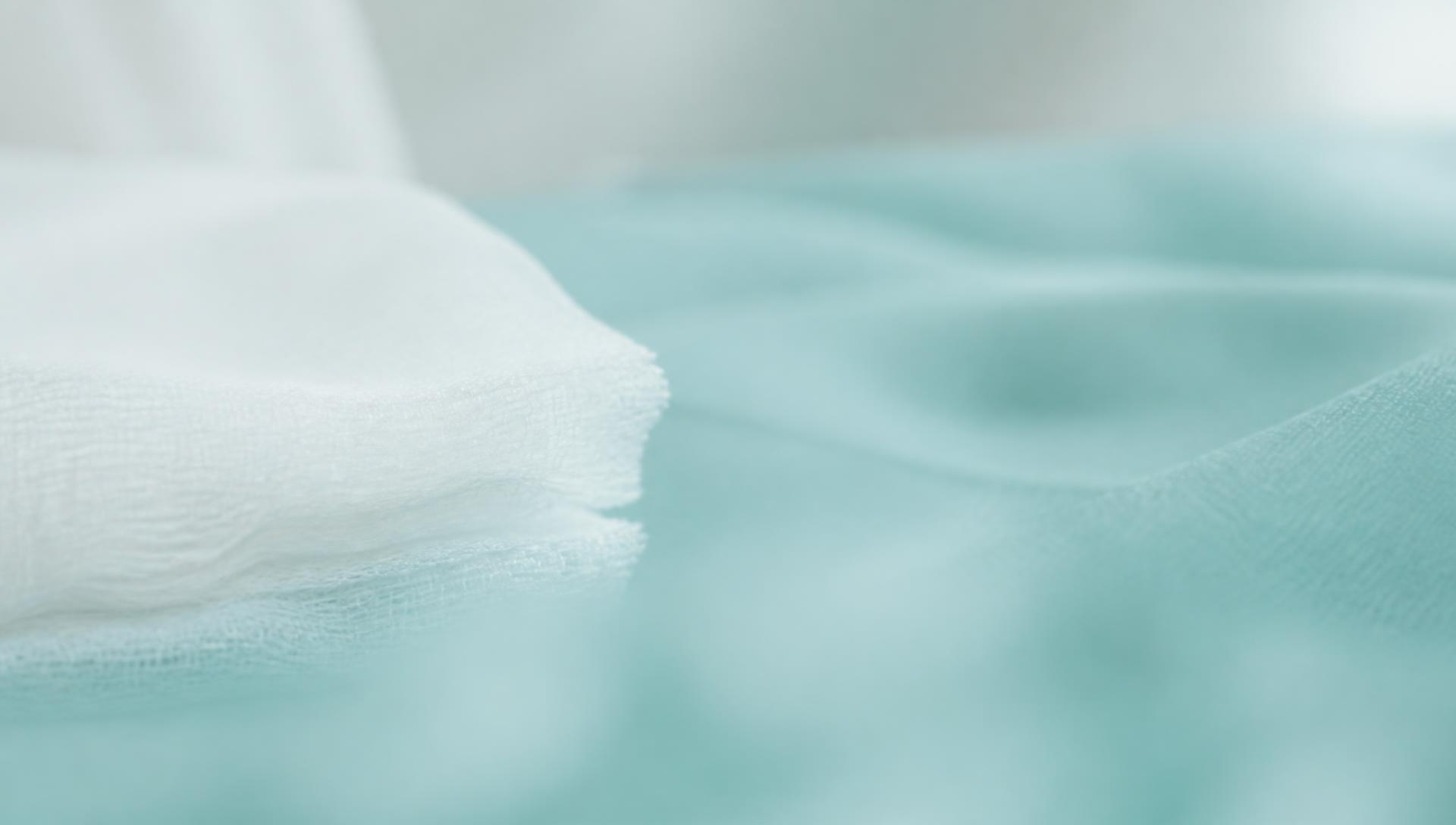 Sterile gauze resting on a pale clinical drape